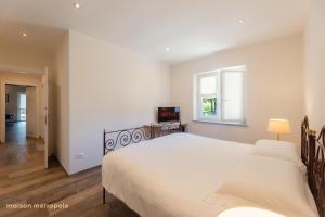 a bedroom with a large bed and a window at Parco della Mandria - La Falchetta House in Robassomero +22 photos