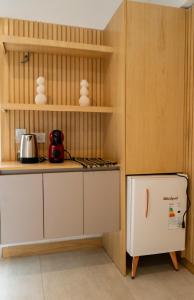 a kitchen with a white refrigerator and shelves at DK Housing in Mendoza