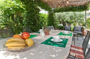 a table with a bowl of fruit on it at Stelle Galeotte Exclusive Holiday Home in Fondi