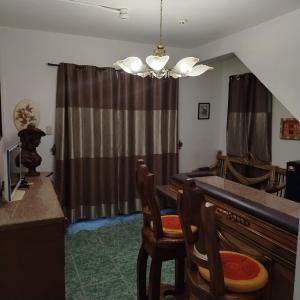 a kitchen with a table and chairs in a room at White & Yellow Castle Hotel and Resort in Calatagan
