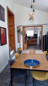a dining room with a wooden table and chairs at St ybars chez Annick et Alain in Saint-Ybars