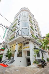 a tall white building with stairs in front of it at Belvilla Near Tan Son Nhat International Airport - Formerly Havana Hotel in Ho Chi Minh City