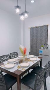 a dining room table with chairs and a dining room at 2 Storey Family House in Casa Verde Mati City in Mati +2 photos