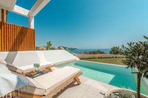 a villa with a swimming pool and a patio at Orizontas Suites in Syvota
