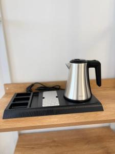 a tea kettle sitting on top of a wooden shelf at Tender to Carafa in Capri +22 photos