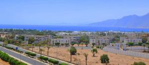a city with the ocean in the background at Tarbouche House Dahab in Dahab