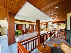 a wooden balcony with a table and chairs at Pondok Wisata Amerta Semaya Agung in Ubud