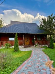 a house with a brick path in front of it at Dimira Котедж з басейном in Slavske