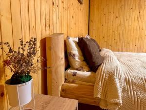 a bedroom with a bed with pillows and a table at Dimira Котедж з басейном in Slavske