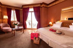 a hotel room with a large bed with a large mirror at Le Grand Hôtel - Domaine De Divonne in Divonne-les-Bains +35 photos