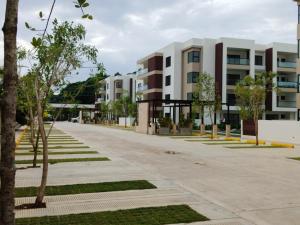an empty street in front of apartment buildings at Prado Suites Las Terrenas in Las Terrenas