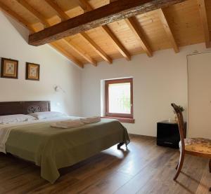 a bedroom with a large bed and a window at Casa dei Colli in Monzambano +44 photos