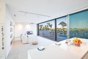 ein Wohnzimmer mit Blick auf das Meer in der Unterkunft Villa Limni Enas - Luxury And Contemporary 3 Bedroom Kapparis Villa With Sea View in Paralimni