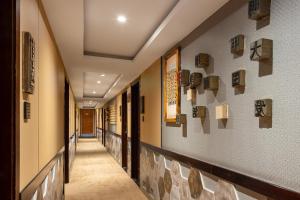 a hallway of a building with a long corridor at East Sacred Hotel-Very close to the Drum Tower,The Lama Temple,Houhai Bar Street,Nanluoguxiang,Tiananmen Square and the Forbidden City, and the subway st ation is also very close in Beijing