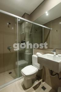 a bathroom with a toilet and a sink and a shower at Comfortable 2 Bed Apt In Molas Lopez in Asuncion +18 photos