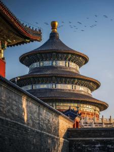 a large building with a tower in the background at East Sacred Hotel-Very close to the Drum Tower,The Lama Temple,Houhai Bar Street,Nanluoguxiang,Tiananmen Square and the Forbidden City, and the subway st ation is also very close in Beijing