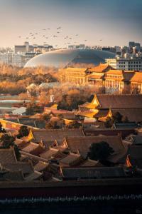 a view of a city with buildings and roofs at East Sacred Hotel-Very close to the Drum Tower,The Lama Temple,Houhai Bar Street,Nanluoguxiang,Tiananmen Square and the Forbidden City, and the subway st ation is also very close in Beijing