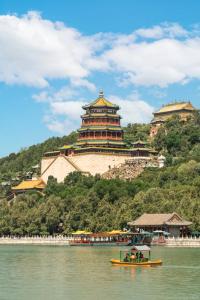 a boat in the water in front of a castle at East Sacred Hotel-Very close to the Drum Tower,The Lama Temple,Houhai Bar Street,Nanluoguxiang,Tiananmen Square and the Forbidden City, and the subway st ation is also very close in Beijing
