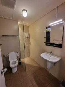 a bathroom with a toilet and a sink at Elite Homes at i-City - WiFi TV Box and 1 Carpark in Shah Alam