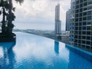 a swimming pool with a view of a river between buildings at Elite Homes at i-City - WiFi TV Box and 1 Carpark in Shah Alam