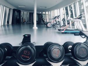 a gym with dumbbells and other exercise equipment in it at Elite Homes at i-City - WiFi TV Box and 1 Carpark in Shah Alam +7 photos