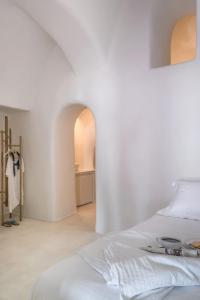 a white bedroom with two beds and a hallway at Amazing Santorini Villa 1 Bedroom Pina Caldera Villa Astounding Caldera Views & Private Plunge Pool Oia in Oia +14 photos