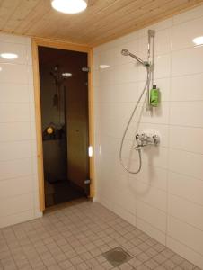 a bathroom with a shower with a shower head at sydtorp charming old house in the countryside in Rosendal