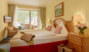 ein Hotelzimmer mit einem großen Bett und einem Fenster in der Unterkunft Ringhotel Bömers Mosel Landhotel in Alf