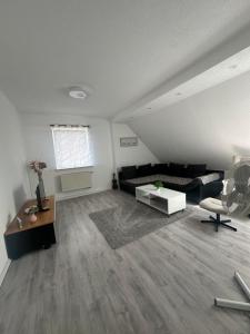 a living room with a couch and a table at Holiday oasis 120m2 near Legoland Günzburg in Günzburg
