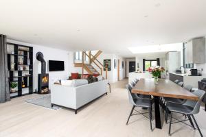 a living room and kitchen with a table and chairs at Huron House ML06 Lower Mill Estate Cotswolds in Somerford Keynes