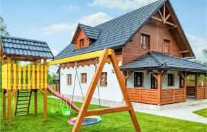 a house with a playground in front of it at Amazing Home In Gospic With Wi-Fi in Gospić