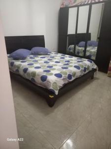 a bedroom with a bed with a comforter on it at maison Sirène in Hammamet