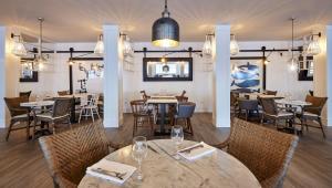 a restaurant with tables and chairs in a room at Delamar 4*Sup-Adults only (18+) in Lloret de Mar