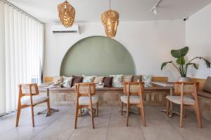 a living room with a couch and a table and chairs at Meshk Airport Hotel in Arnavutköy