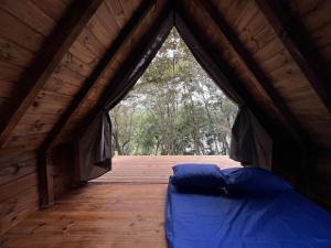 a bed in a tent with a wooden deck at Belas Mairiporã in Mairiporã +69 photos