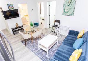 a living room with a blue couch and a table at Lux Capitol Hill Vacation Home, In-House Services in Washington