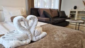 dwa łabędzie, ręczniki siedzące na kanapie w obiekcie Apartament Rynek 40m2 Wrocław Stare Miasto we Wrocławiu