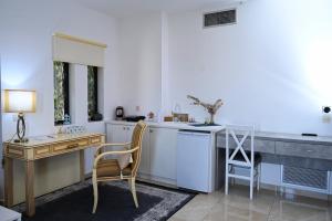 a kitchen with a desk and a table and a chair at Ducato di Aria , Luxury Apartments in Nafplio