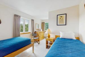 a bedroom with two beds and a desk at Snow Creek 115 in Warren +47 photos