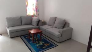 a living room with a couch and a table at Juriz staycation Place in Santo Tomas