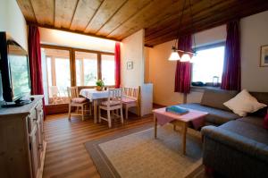 a living room with a couch and a table at Hofbauer in Seebruck