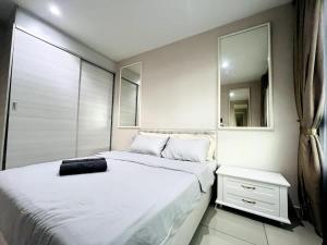 a bedroom with a large white bed and a mirror at Gem Homes at i-City - WiFi TV Box and 1 Carpark in Shah Alam