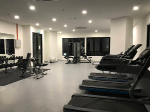 a gym with rows of treadmills and machines at Gem Homes at i-City - WiFi TV Box and 1 Carpark in Shah Alam +9 photos