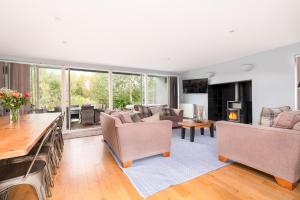 a living room with couches and a fireplace at Ducklings CW65 Lower Mill Estate Cotswolds in Somerford Keynes +19 photos