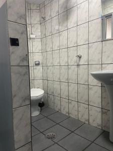 a bathroom with a shower and a toilet and a sink at Hotel Sany SP- Metrô Paulista in Sao Paulo