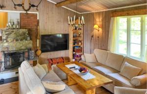 a living room with a couch and a table at 2 Bedroom Nice Home In Hafjell in Hafjell