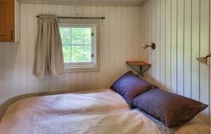 a bed in a room with a window at 2 Bedroom Nice Home In Hafjell in Hafjell +3 photos
