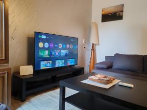 a living room with a couch and a flat screen tv at House of Tea in Bjelovar