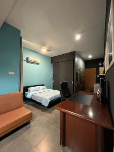 a bedroom with a bed and a desk and a table at Comfy Empire Damansara Studio in Petaling Jaya