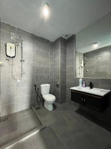 a bathroom with a toilet and a sink and a shower at Comfy Empire Damansara Studio in Petaling Jaya